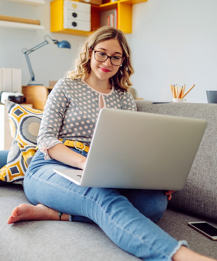 A woman uses her laptop to read about the dark web.